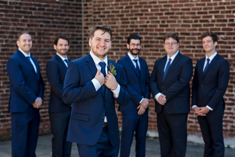 A groom grabs his suit.